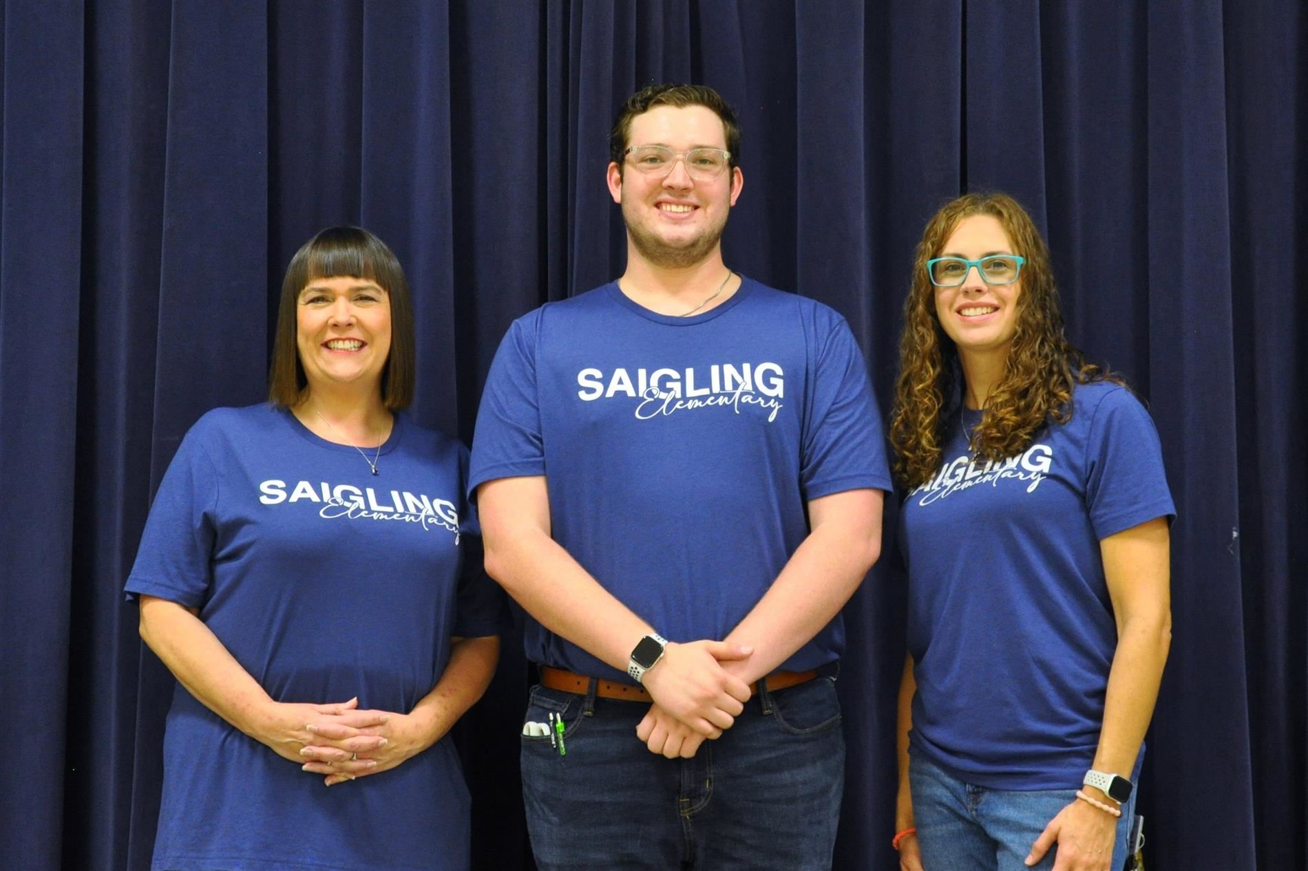 A picture of Ms. Rizvan, Mr. Setford, and Ms. Josephson standing next to each other smiling.